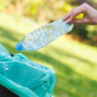 hand-of-woman-throwing-bottle-into-recycling-bin-2021-08-26-18-15-53-utc.jpg