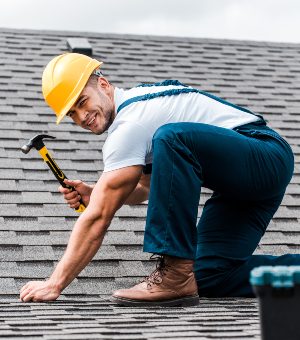 selective-focus-of-handsome-handyman-repairing-roo-5HJCQU9-2.jpg