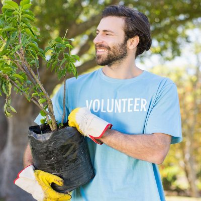 a-volunteer-man-holding-plant-DSXU42K.jpg